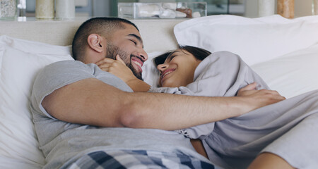 Canvas Print - Couple, love and smile in bed, bonding and romance of intimacy, special moment and trust together at home. Happy young man, woman and partner in relationship, honeymoon and relax for care in bedroom