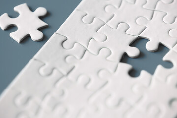 Wall Mural - Clean puzzle elements on the red background. Empty puzzle piece on the table. Teamwork concept.