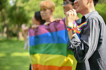 Close-up image of a group of diverse teen Asian friends joining the Pride Month parade