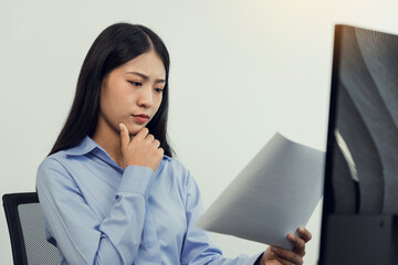 Wall Mural - concentrated asian woman brainstorming while coding data on desktop pc while working on computer cod