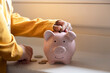 © Westend61 - Boy saving money in piggy bank