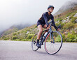 © Michael C/peopleimages.com - Road, woman and cycling with fitness, health and training for wellness, cardio and endurance. Female person, biker and cyclist with workout, street and practice with a helmet, glasses and exercise