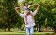 © D Fernandes/peopleimages.com - Indian dad, daughter and shoulders in park with smile, airplane game or piggyback in nature on holiday. Man, girl and playing together in garden, woods and summer sunshine for happy family vacation