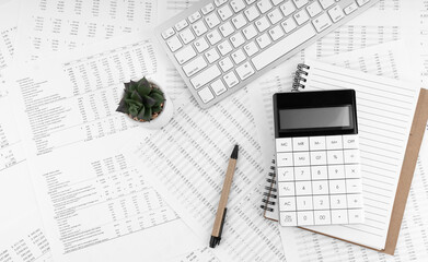 Poster - Calculator, keyboard, pen and notebook lying on financial statement . Financial concept.