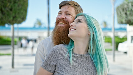 Poster - Man and woman couple smiling confident standing together at street