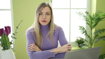 Sticker - Young blonde woman using laptop sitting on table at home