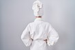 © Krakenimages.com - Blonde caucasian woman wearing bathrobe standing backwards looking away with arms on body