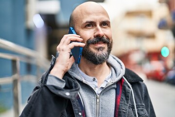 Sticker - Young bald man smiling confident talking on the smartphone at street