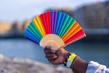 Wall Mural - Colorful rainbow fan during gay pride, LGBT collective fan by the sea