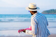 © unai - Portrait of black ethnic man enjoy summer vacation on the beach playing ukulele by the sea