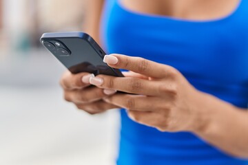 Sticker - Young beautiful latin woman using smartphone at street