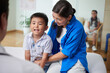 © DragonImages - Joyful kid talking to doctor when visiting him after recovey