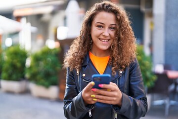 Poster - Young beautiful hispanic woman smiling confident using smartphone at street