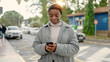 © Krakenimages.com - African american woman using smartphone with serious expression at street