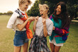 © Jacob Lund - Mature women screaming with laughter in a park, celebrating their friendship