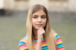 portrait of pondering teen girl with blonde hair. portrait of teen girl outdoor.