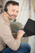 © auremar - smiling young man using technology to work