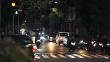 City traffic at night. A busy intersection in Asia. Traffic jam at the intersection of motorcycles.