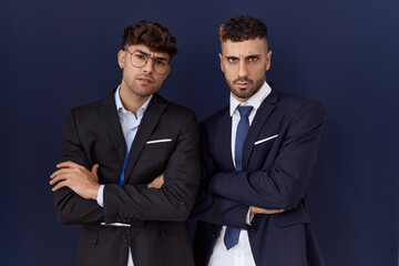 Sticker - Two hispanic business men wearing business clothes skeptic and nervous, disapproving expression on face with crossed arms. negative person.