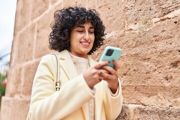 Sticker - Young middle east woman excutive smiling confident using smartphone at street