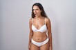 © Krakenimages.com - Young hispanic woman wearing white lingerie angry and mad screaming frustrated and furious, shouting with anger. rage and aggressive concept.