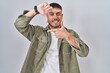 © Krakenimages.com - Young hispanic man standing over isolated background smiling making frame with hands and fingers with happy face. creativity and photography concept.