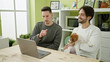© Krakenimages.com - Two men couple using laptop sitting on table with dog at dinning room