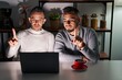 © Krakenimages.com - Homosexual couple using computer laptop pointing with finger up and angry expression, showing no gesture