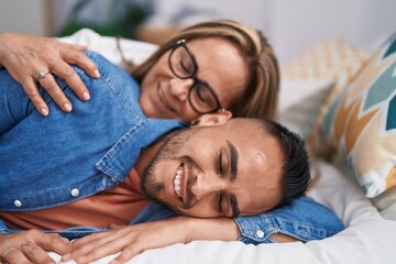 Poster - Man and woman mother and son lying on bed at bedroom