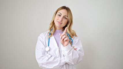 Poster - Young beautiful hispanic woman doctor standing with serious expression saying no with finger over isolated white background