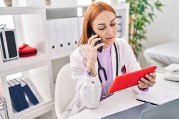 Sticker - Young caucasian woman doctor using touchpad talking on smartphone at clinic