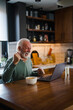 © Dragana Gordic - Happy excited old elderly man winner excited by reading good news looking at laptop, overjoyed senior mature grandfather watching game online celebrating goal bid bet win great result victory concept