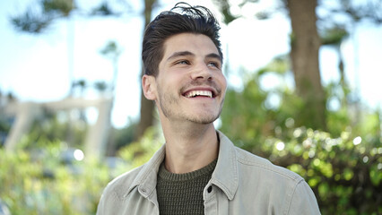 Sticker - Young hispanic man smiling confident looking to the side at park