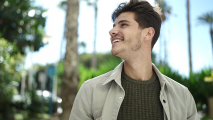 Sticker - Young hispanic man smiling confident looking to the side at park