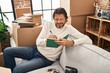 © Krakenimages.com - Middle age man writing on notebook sitting on sofa at new home