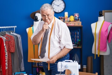 Sticker - Middle age grey-haired man tailor smiling confident looking clothing design at tailor shop