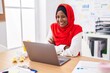© Krakenimages.com - Young beautiful woman business worker using laptop sitting with arms crossed gesture at office