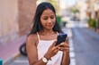 © Krakenimages.com - Young beautiful woman using smartphone with relaxed expression at street