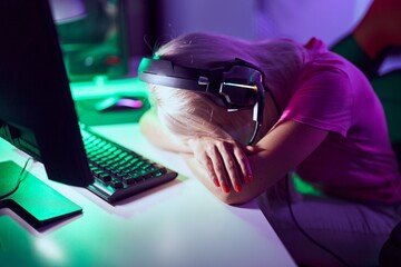 Wall Mural - Young blonde woman streamer stressed  using computer at gaming room