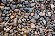 Crushed Stone On The Seashore. Selective Focus On Object. The Stones Were Laid On The Ground In The Garden As A Background. Background Blur. Pebble Stones Background.