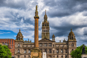 city chambers and scott monument in glasgow, scotland, united kingdom