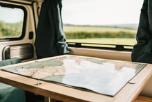 Generative AI Illustration Of Camper Van Interior With Map Placed On Table Under Glass During Road Trip Through Countryside
