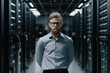 © ADDICTIVE STOCK - Generative AI illustration of serious bearded male engineer with eyeglasses looking at camera while standing among server shelves with wires