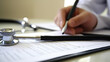 © Natalia - Doctor writing medical report hands close up