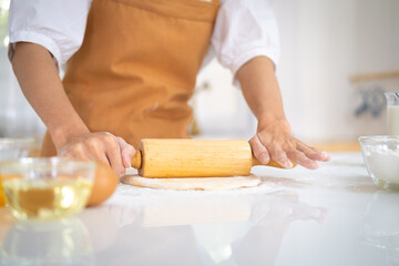 Close up view of bakers are working. Homemade bread. Hands preparing dough on table for homemade pastry and bread. Cooking and baking at home concept.hands of the baker's female knead dough .