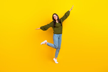 Poster - Full size photo of overjoyed nice girl stand one leg arms wings good mood isolated on yellow color background