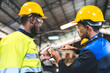 © chokniti - professional business industry technician wearing safety helmet working to maintenance service and checking factory equipment, a work of engineer occupation in manufacturing construction technology