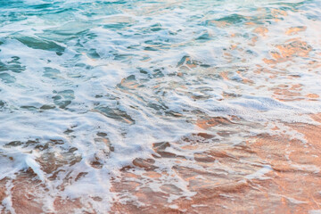 Wall Mural - Sea shore with white foam on a sunny morning. Natural background