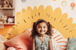 © Trinette Reed - Portrait of adorable Indian little girl in her room smiling. Generative AI.