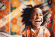 © Trinette Reed - Portrait of adorable joyful little Black girl in her room laughing.